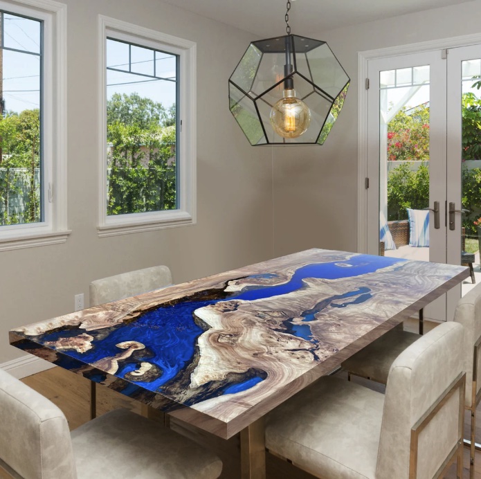 Dining table in light burl with a river of Klein blue resin